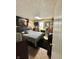 Cozy bedroom with a black bed frame, modern lighting, and carpeted floors at 1831 Beckenbauer Ln, Indianapolis, IN 46214