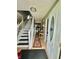 Inviting entryway featuring hardwood floors, staircase, and charming decor, setting a welcoming tone for the home at 1831 Beckenbauer Ln, Indianapolis, IN 46214