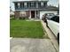 Charming two-story home with a well-manicured lawn, brick accents, and attached garage at 1831 Beckenbauer Ln, Indianapolis, IN 46214