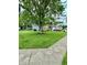 View of the home showing the large front yard with a beautiful tree and established lawn at 1831 Beckenbauer Ln, Indianapolis, IN 46214