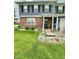 Close up of well maintained front lawn with flower bed and partial brick facade on home at 1831 Beckenbauer Ln, Indianapolis, IN 46214