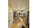 Well-lit kitchen boasts stainless steel appliances, an island with bar stools, and neutral cabinetry at 1831 Beckenbauer Ln, Indianapolis, IN 46214