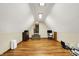 A finished attic with hardwood floors, dormer windows and neutral colors offers a flexible living space at 1850 Longest Dr, Franklin, IN 46131