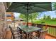 Charming back deck with an outdoor dining area, umbrella, and view of the expansive green lawn and neighborhood at 1850 Longest Dr, Franklin, IN 46131