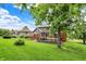 Lush backyard features a large deck area, mature trees, and well-kept lawn, providing a serene outdoor retreat at 1850 Longest Dr, Franklin, IN 46131
