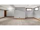 Finished basement featuring neutral walls, carpet, natural wood trim, and two windows offering natural light at 1850 Longest Dr, Franklin, IN 46131