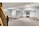 A finished basement offers additional living space with carpeted floors and neutral gray walls at 1850 Longest Dr, Franklin, IN 46131