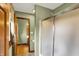 Bathroom showcasing shower with glass doors, tile flooring, and wood door trim at 1850 Longest Dr, Franklin, IN 46131