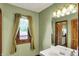 A light and airy bathroom featuring a window, a decorative mirror, and a white vanity at 1850 Longest Dr, Franklin, IN 46131