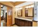 Bathroom featuring double vanity, granite counters, dark cabinets, and a glass-enclosed shower at 1850 Longest Dr, Franklin, IN 46131