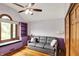 Bedroom featuring wood floors, a gray sofa, and custom shelves underneath the window at 1850 Longest Dr, Franklin, IN 46131