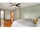 Bedroom with hardwood floors, a comfortable bed, and two doorways at 1850 Longest Dr, Franklin, IN 46131