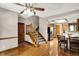 Open dining area with hardwood floors, stairs to upper level, and connects to the kitchen at 1850 Longest Dr, Franklin, IN 46131