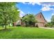 Beautiful home with lush green lawn, mature trees, and brick exterior at 1850 Longest Dr, Franklin, IN 46131