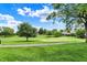 Picturesque golf course featuring manicured greens, mature trees, and a paved cart path under a beautiful sky at 1850 Longest Dr, Franklin, IN 46131