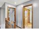 Upstairs hallway featuring hardwood floors and paneled wooden doors at 1850 Longest Dr, Franklin, IN 46131