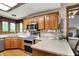 Functional kitchen features a breakfast bar, wooden cabinets, stainless steel appliances, and hardwood floors at 1850 Longest Dr, Franklin, IN 46131