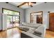 Well-lit living room with hardwood floors, ceiling fan, and access to the deck through sliding glass doors at 1850 Longest Dr, Franklin, IN 46131