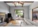 Cozy living room with hardwood floors, fireplace, ceiling fan, and sliding glass doors to the deck at 1850 Longest Dr, Franklin, IN 46131