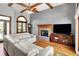 Bright living room with hardwood floors, fireplace, large windows, and comfortable seating at 1850 Longest Dr, Franklin, IN 46131