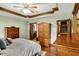 Spacious main bedroom with a ceiling fan, hardwood floors, and a doorway leading to an ensuite bathroom at 1850 Longest Dr, Franklin, IN 46131
