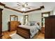 Large primary bedroom featuring beautiful hardwood floors, bright natural light, and wooden trim at 1850 Longest Dr, Franklin, IN 46131