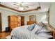 Comfortable main bedroom with hardwood floors, natural light, and a doorway into the ensuite bathroom at 1850 Longest Dr, Franklin, IN 46131