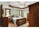 This spacious bedroom has lots of natural light, dark hardwood floors, and detailed crown molding at 1850 Longest Dr, Franklin, IN 46131