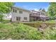 Expansive backyard featuring a multi-tiered deck, mature landscaping, and a serene wooded backdrop at 18514 Oriental Oak Ct, Noblesville, IN 46062