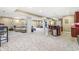 Open finished basement with a large seating area, bar with stools, and tiled kitchen area at 18514 Oriental Oak Ct, Noblesville, IN 46062