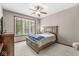 Bedroom featuring carpet floors, a ceiling fan, a window with green views, and a gray bed at 18514 Oriental Oak Ct, Noblesville, IN 46062