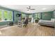 Green-walled bedroom with multiple windows, ceiling fan, and a workstation with computer at 18514 Oriental Oak Ct, Noblesville, IN 46062