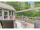 Inviting outdoor deck featuring cozy seating around a fire pit with wooded views at 18514 Oriental Oak Ct, Noblesville, IN 46062