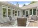 Inviting outdoor deck featuring cozy seating around a fire pit with wooded views at 18514 Oriental Oak Ct, Noblesville, IN 46062