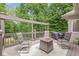 Inviting outdoor deck featuring cozy seating around a fire pit with wooded views and a grill at 18514 Oriental Oak Ct, Noblesville, IN 46062