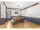 Bright dining room boasts a stylish light fixture, wainscoting and hardwood floors at 18514 Oriental Oak Ct, Noblesville, IN 46062