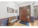 Welcoming entryway with hardwood floors, bench seating, and a beautifully crafted front door at 18514 Oriental Oak Ct, Noblesville, IN 46062