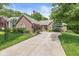 Inviting brick home featuring a well-maintained lawn and a lush garden at 18514 Oriental Oak Ct, Noblesville, IN 46062