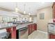 Wet bar area in basement with granite countertops, stainless steel refrigerator, and pendant lighting at 18514 Oriental Oak Ct, Noblesville, IN 46062