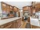 A gourmet kitchen features stainless appliances, wooden cabinetry, and a stone tile backsplash at 18514 Oriental Oak Ct, Noblesville, IN 46062