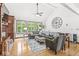 Bright living room with hardwood floors, vaulted ceilings, and large windows overlooking the yard at 18514 Oriental Oak Ct, Noblesville, IN 46062