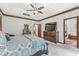 Spacious main bedroom featuring carpet floors, a ceiling fan, and a dresser with a television at 18514 Oriental Oak Ct, Noblesville, IN 46062