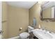 Cozy powder room featuring a pedestal sink, toilet, and decorative mirror at 18514 Oriental Oak Ct, Noblesville, IN 46062