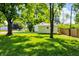 Large grassy backyard with mature trees offering ample shade and greenery at 1868 N Hawthorne Ln, Indianapolis, IN 46218
