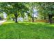 Well-manicured backyard featuring a lush green lawn and mature trees at 1868 N Hawthorne Ln, Indianapolis, IN 46218