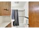 Bathroom features a shower with black trim, storage, and white towels at 1868 N Hawthorne Ln, Indianapolis, IN 46218