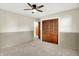 Comfortable bedroom with plush carpeting, wood closet, and a ceiling fan at 1868 N Hawthorne Ln, Indianapolis, IN 46218