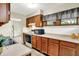 Bright kitchen with wooden cabinets, white countertops, and stainless steel microwave at 1868 N Hawthorne Ln, Indianapolis, IN 46218