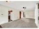 Inviting living room with neutral carpet and a view into the kitchen at 1868 N Hawthorne Ln, Indianapolis, IN 46218