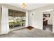 Inviting living room with plush carpeting, neutral tones, large windows, and a ceiling fan at 1868 N Hawthorne Ln, Indianapolis, IN 46218